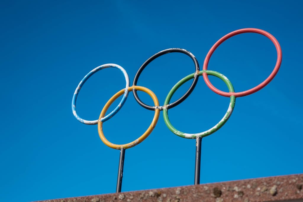 The olympic rings are displayed on top of a building